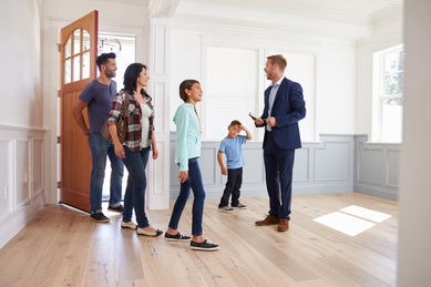 Realitor showing a house to a family