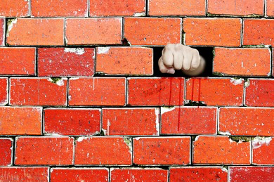 Man Putting a Fist Through a Wall